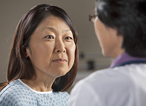 Woman talking to healthcare provider.